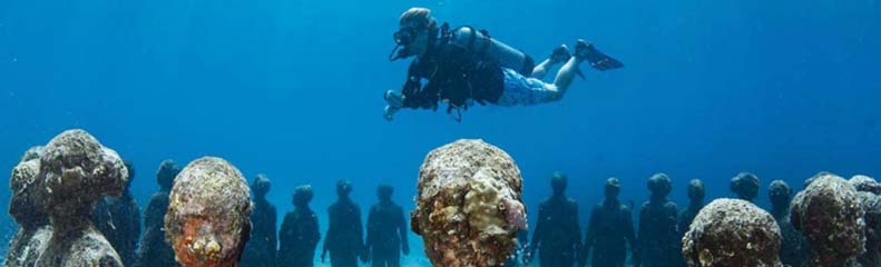 man scuba diving in coyaba beach