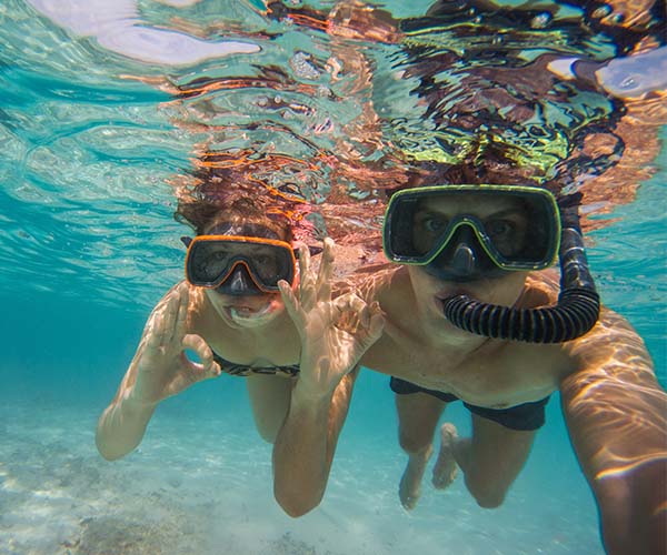 young kids underwater snorkeling
