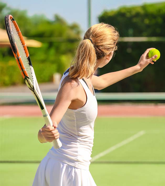 woman in white playing tennis