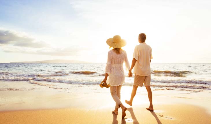 couple holding hands on the beach