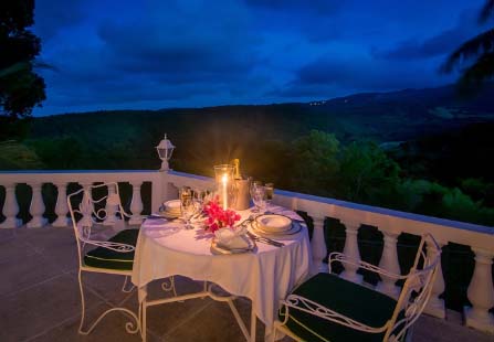 pavilion balcony at night with dinner table and chairs